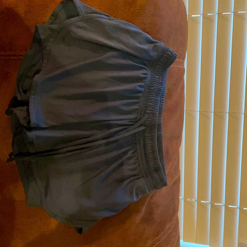 Athletic shorts with connected bottom shorts